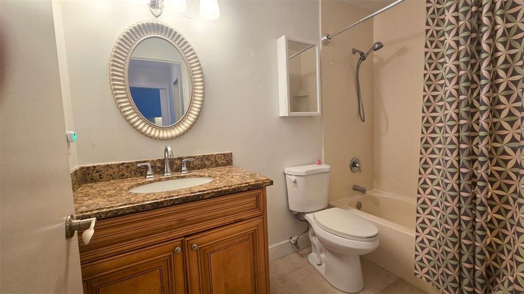 7667 North Wickham Road, Unit 522 Melbourne, FL 32940 - Photo 14 of 25 a bathroom with a sink a toilet and a mirror