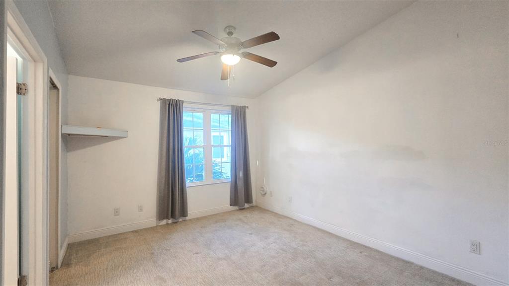 7667 North Wickham Road, Unit 522 Melbourne, FL 32940 - Photo 16 of 25 an empty room with chandelier fan