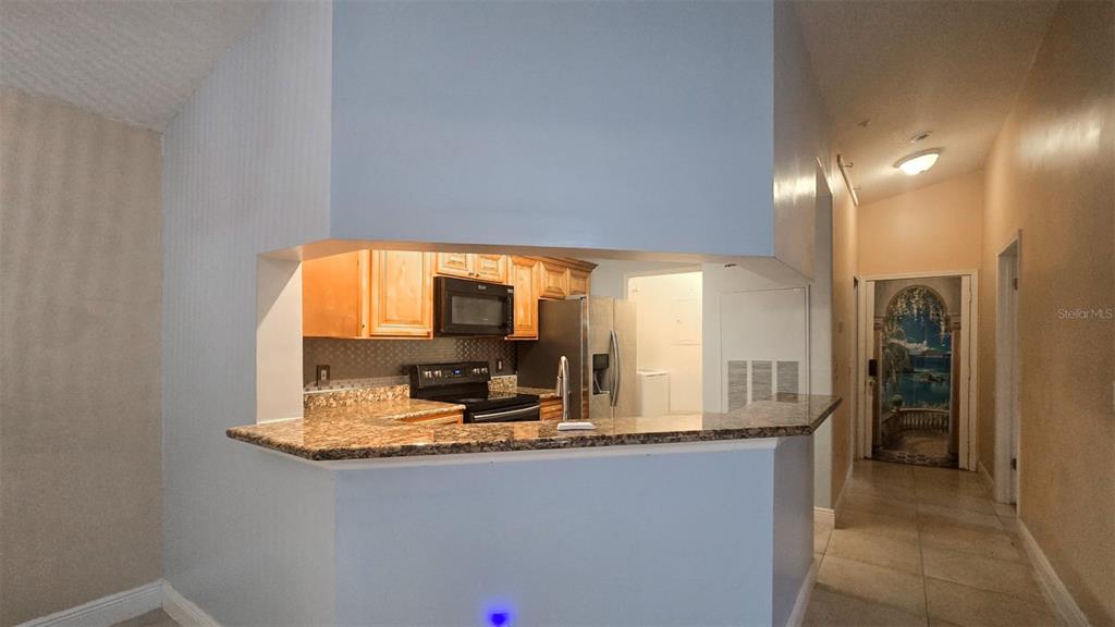 7667 North Wickham Road, Unit 522 Melbourne, FL 32940 - Photo 7 of 25 a view of kitchen with granite countertop window and refrigerator