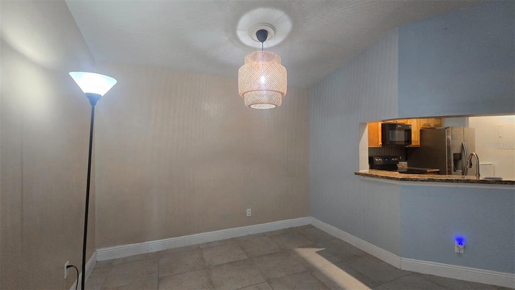 7667 North Wickham Road, Unit 522 Melbourne, FL 32940 - Photo 8 of 25 a room with wooden floor and mirror