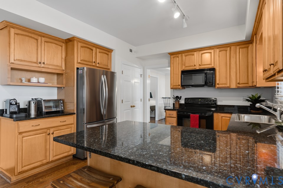 3009 Sable Road Henrico, VA 23233 - Photo 16 of 51 a kitchen with stainless steel appliances granite countertop a stove a sink and a microwave