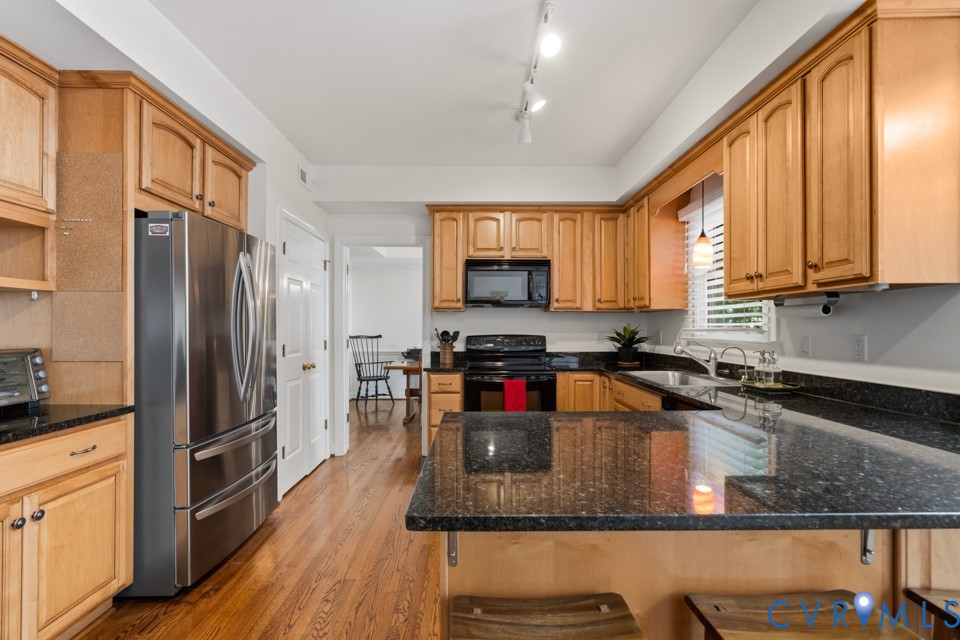 3009 Sable Road Henrico, VA 23233 - Photo 17 of 51 a kitchen with stainless steel appliances granite countertop a refrigerator a stove top oven a sink and dishwasher