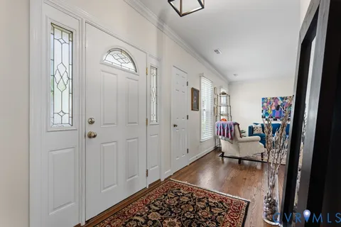 a living room with furniture a rug and a window