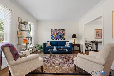 a living room with furniture and painting on the wall