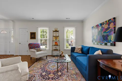 a view of a a dining room with furniture window and wooden floor
