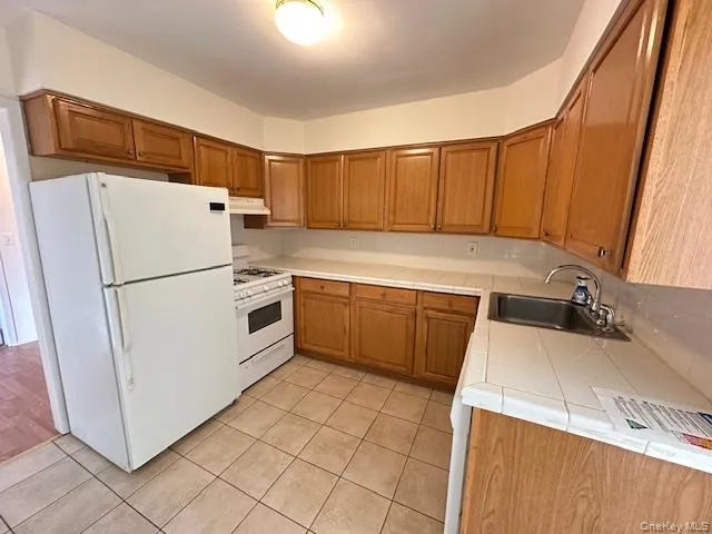 a kitchen with a stove a refrigerator and a sink