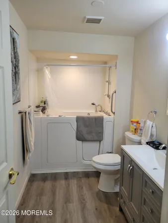 a bathroom with a sink toilet and a mirror