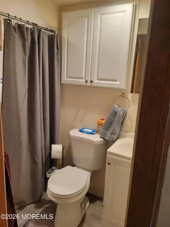 a bathroom with a toilet and a shower curtain