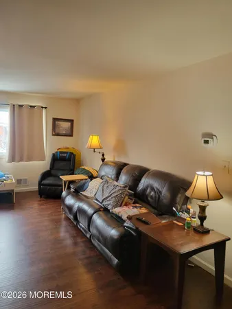 a living room with furniture and a lamp