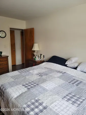 a bedroom with a bed and a lamp