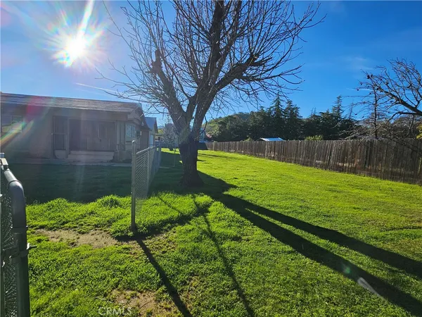 a view of a house with backyard and patio