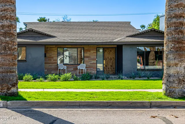a front view of a house with a yard