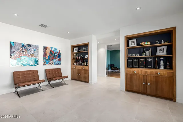a large kitchen with stainless steel appliances a sink and a refrigerator