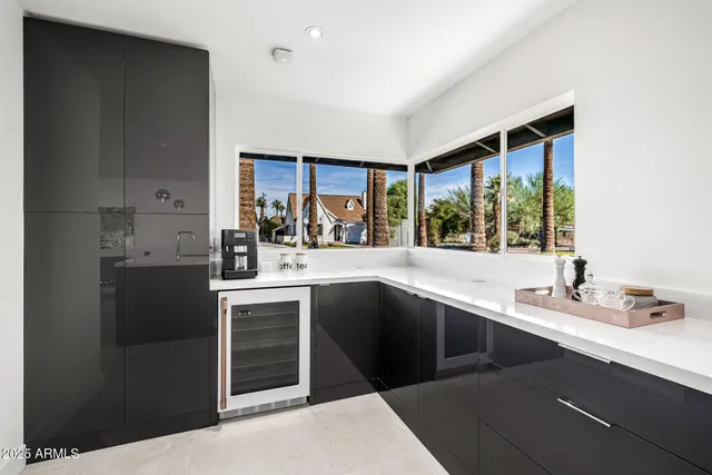 a kitchen with stainless steel appliances granite countertop a sink and a refrigerator