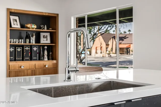 a kitchen with a sink cabinets and window