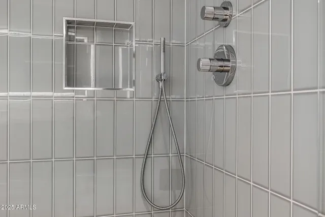 a white bath tub sitting next to a bathroom