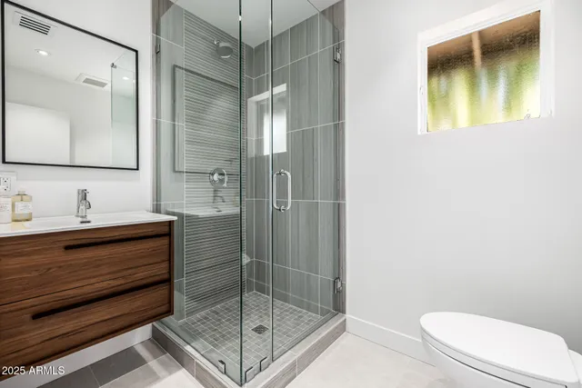 a bedroom with a bed and large window