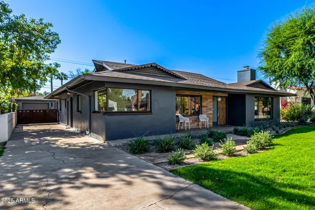 a front view of a house with a garden