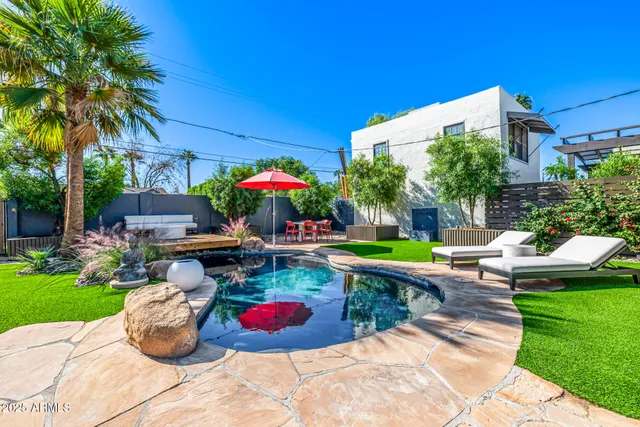 a view of a chairs and table in backyard of the house