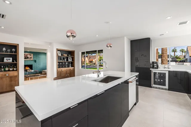 a kitchen with stainless steel appliances granite countertop a sink and a refrigerator