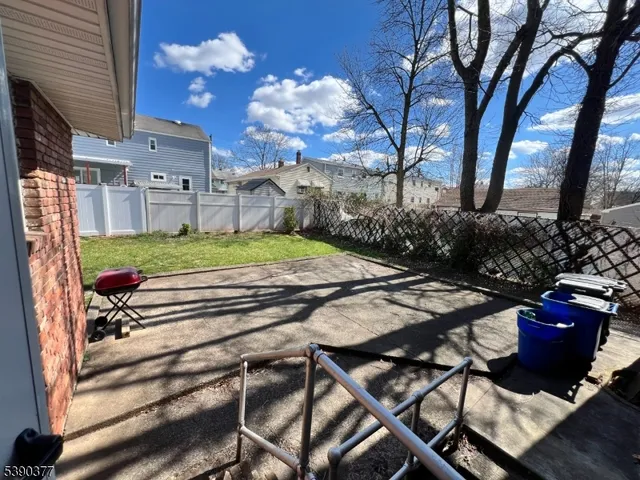 a view of backyard with seating space and trees