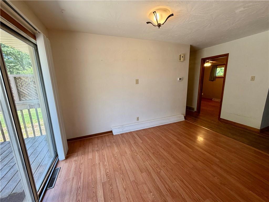 121 Kemar Drive Butler, PA 16002 - Photo 12 of 31 a view of an empty room with wooden floor and a window