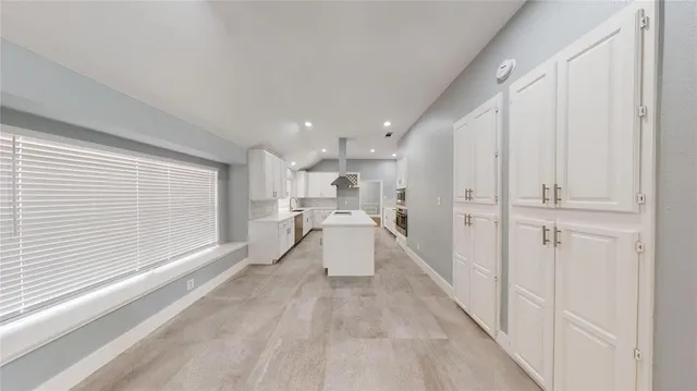 a bathroom with a sink a mirror and window