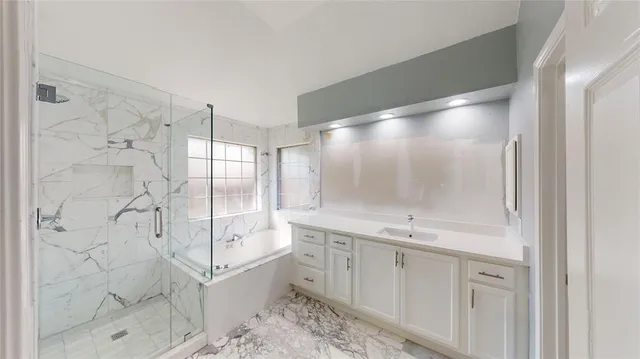 a bathroom with a granite countertop sink mirror and shower