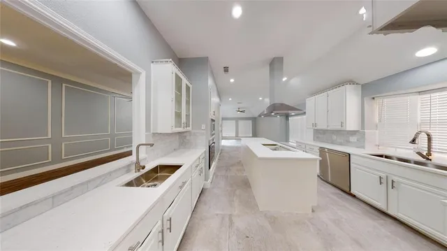 a kitchen with a sink stove and cabinets