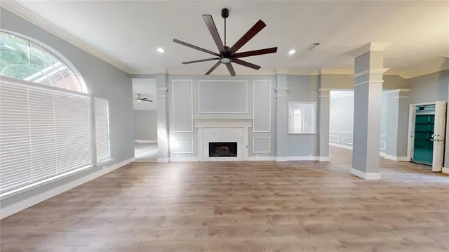 a view of a livingroom with a fireplace and window