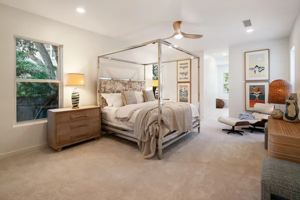 a spacious bedroom with a bed and a chandelier