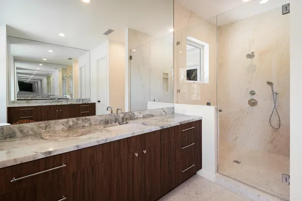 a bathroom with a granite countertop sink mirror and double