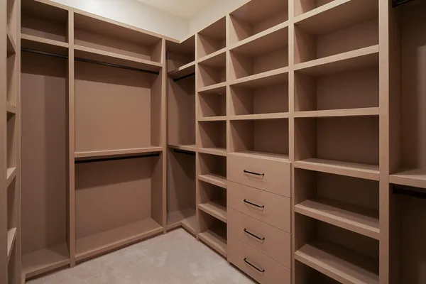 a view of walk in closet with empty racks