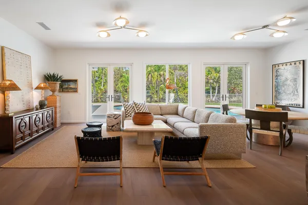 a living room with furniture and large windows