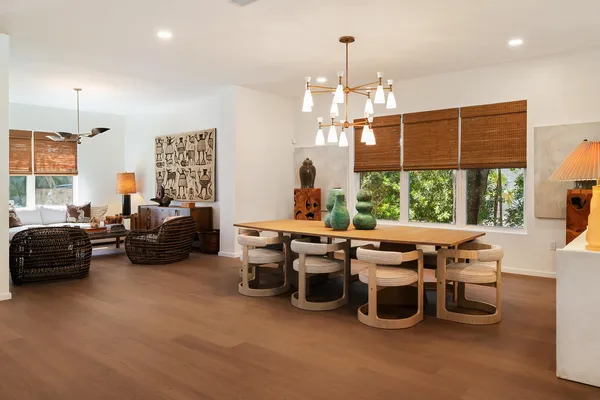 a very nice looking living room with a large window and a chandelier