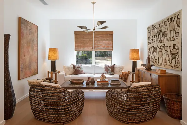 a living room with furniture a large window and chandelier