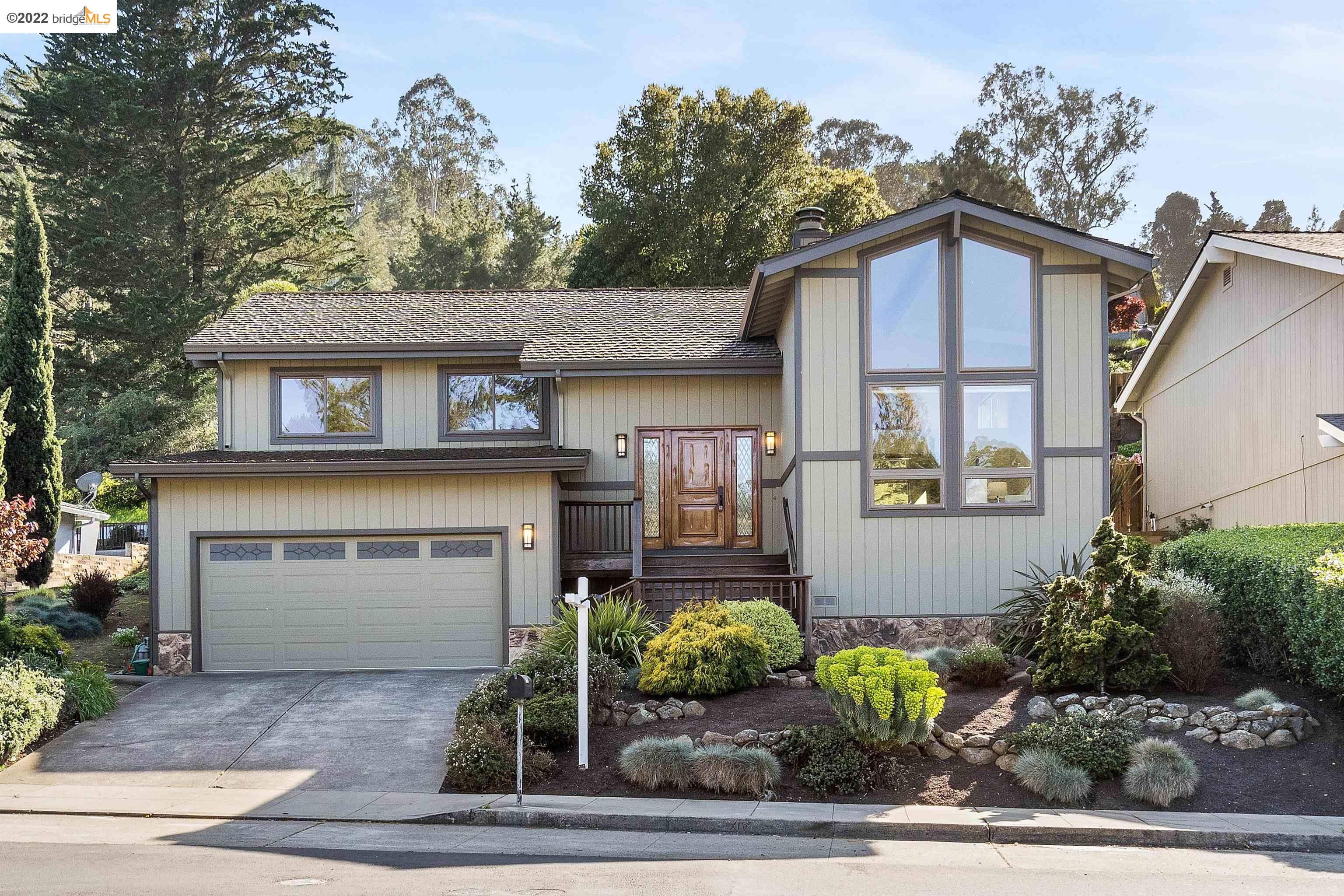 a front view of a house with garden