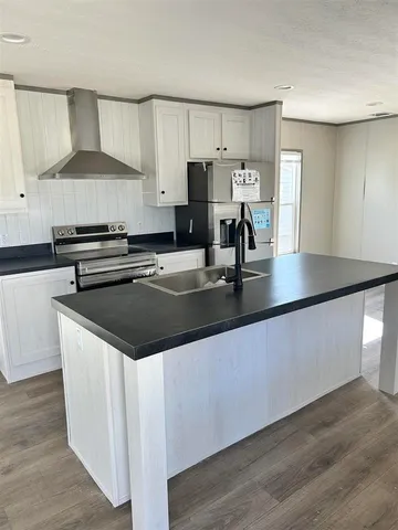 a kitchen with stainless steel appliances granite countertop a stove and a sink
