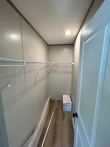 a living room with hard wood floors and a window