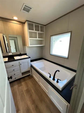 a bathroom with a double vanity sink mirror and toilet