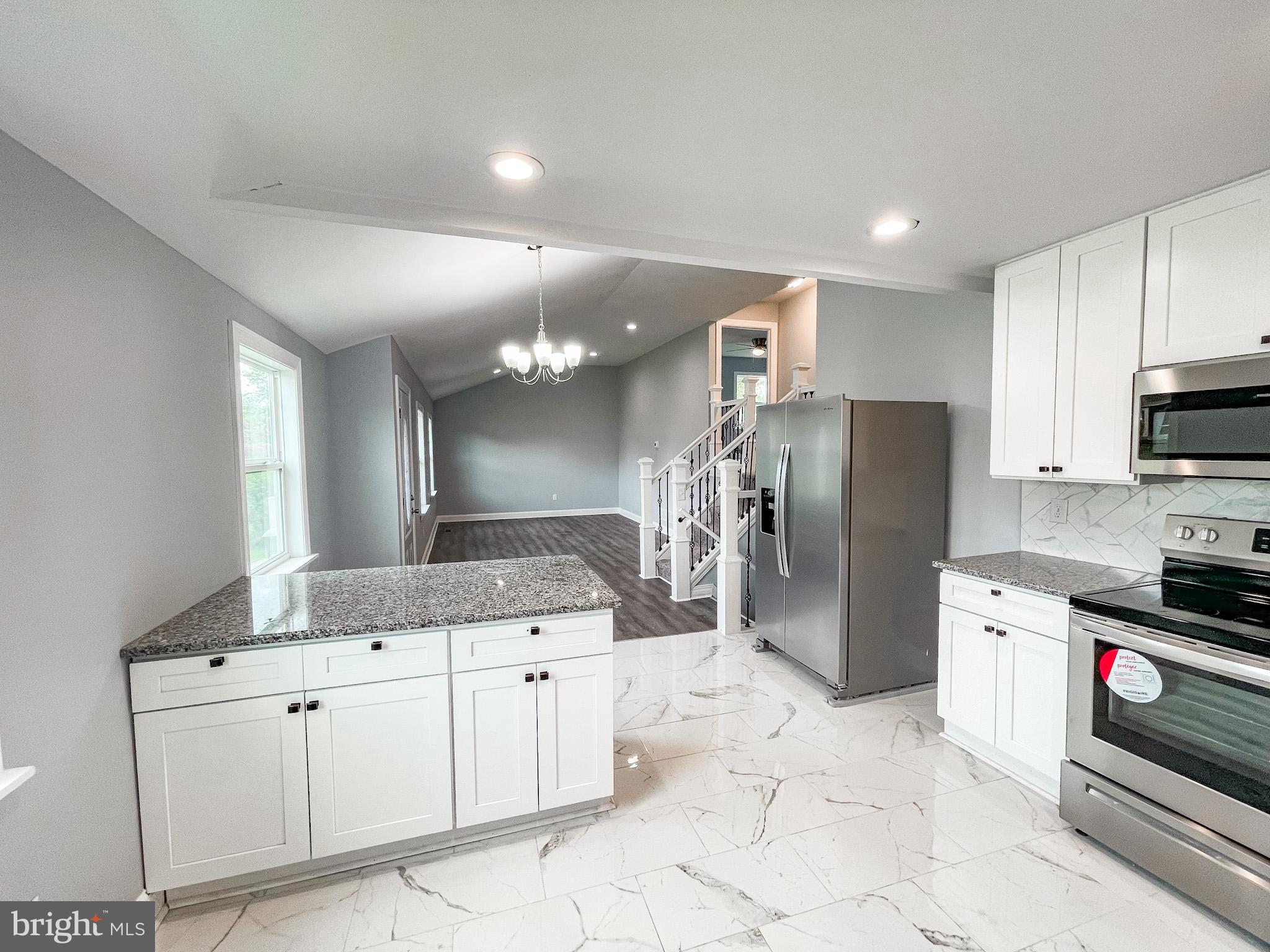 34 Marlyn Road Newark, DE 19713 - Photo 11 of 32 a kitchen with a sink a refrigerator and a stove top oven