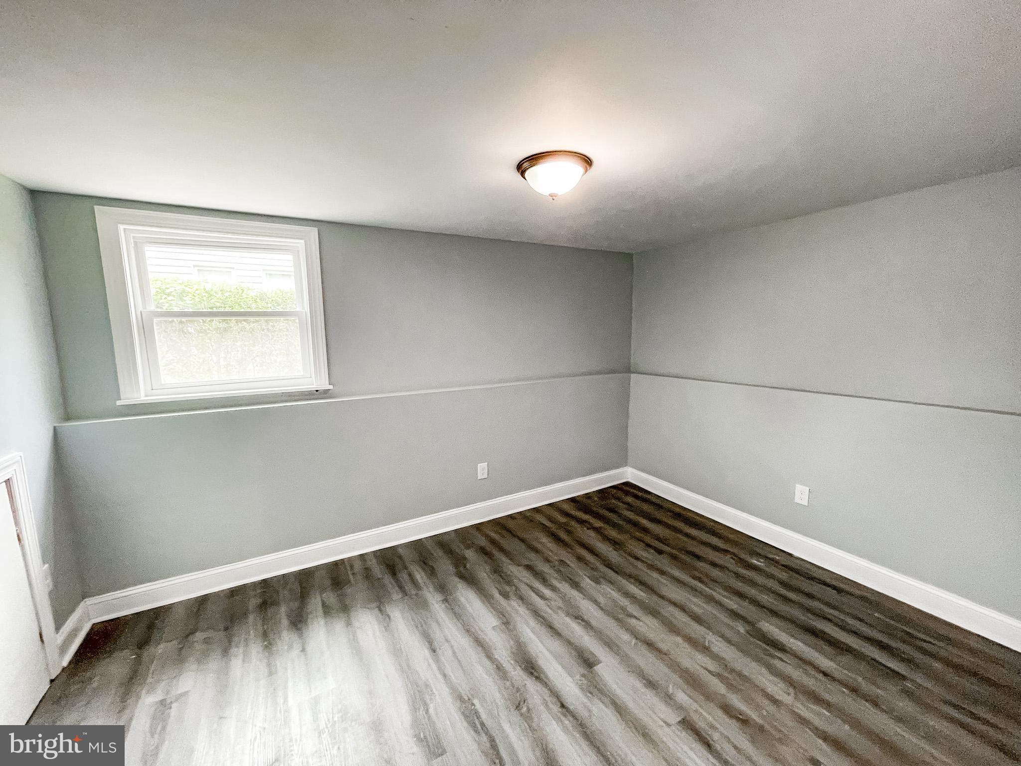 34 Marlyn Road Newark, DE 19713 - Photo 15 of 32 an empty room with wooden floor and windows