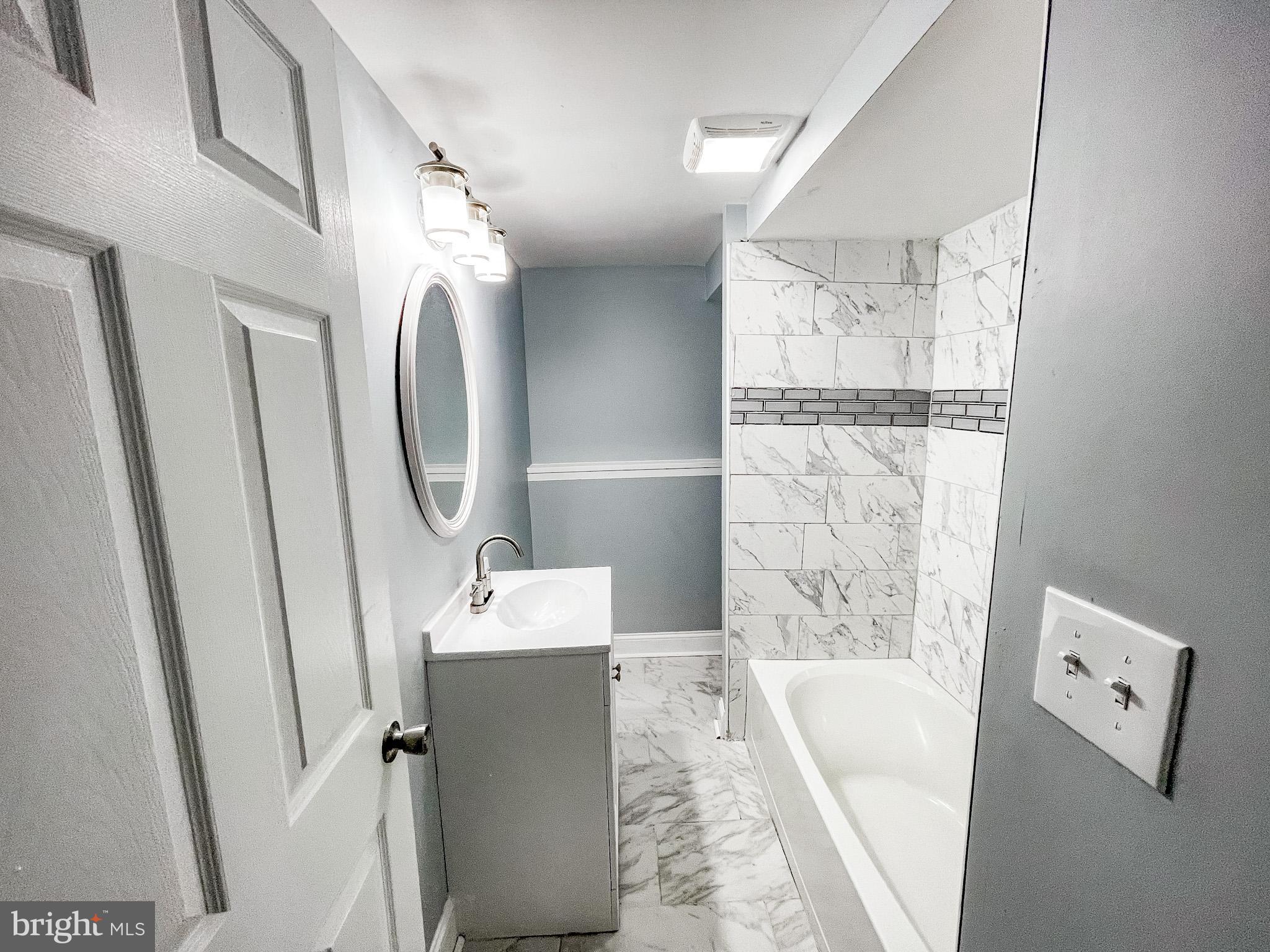 34 Marlyn Road Newark, DE 19713 - Photo 16 of 32 a bathroom with a tub sink and mirror