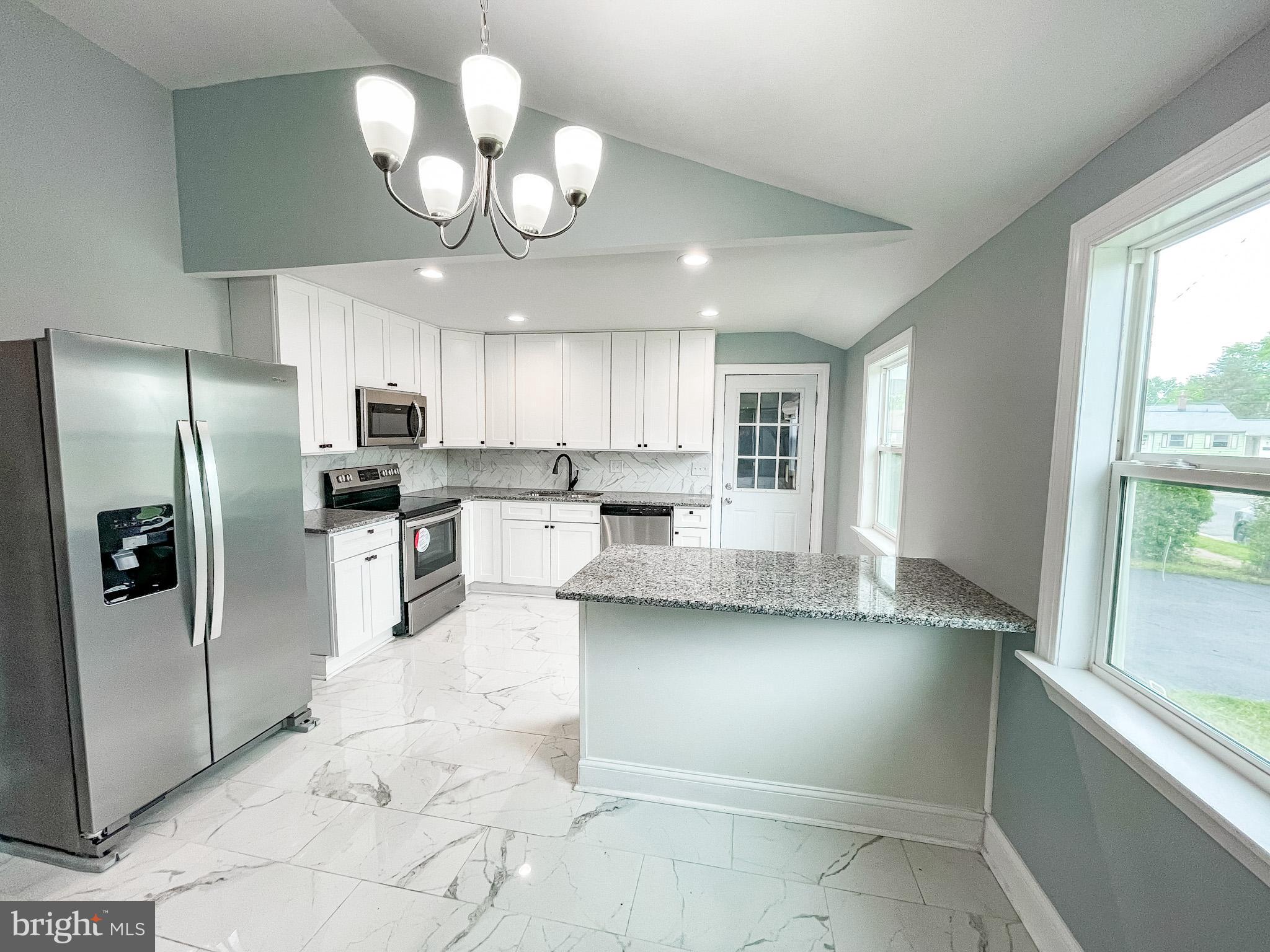 34 Marlyn Road Newark, DE 19713 - Photo 6 of 32 a kitchen with stainless steel appliances granite countertop a refrigerator a sink dishwasher a stove and white cabinets with wooden floor