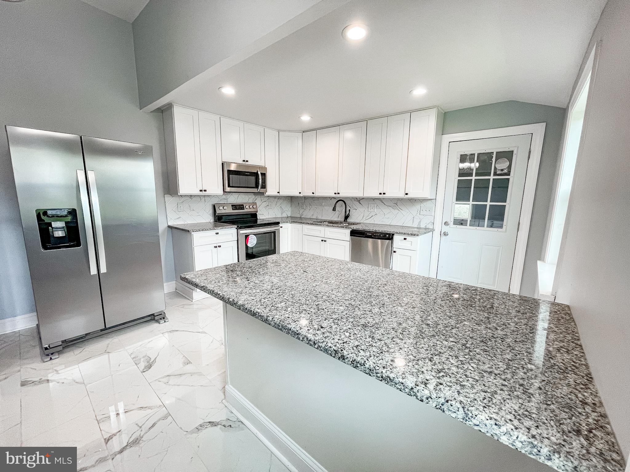 34 Marlyn Road Newark, DE 19713 - Photo 7 of 32 a kitchen with stainless steel appliances granite countertop a sink stove and refrigerator