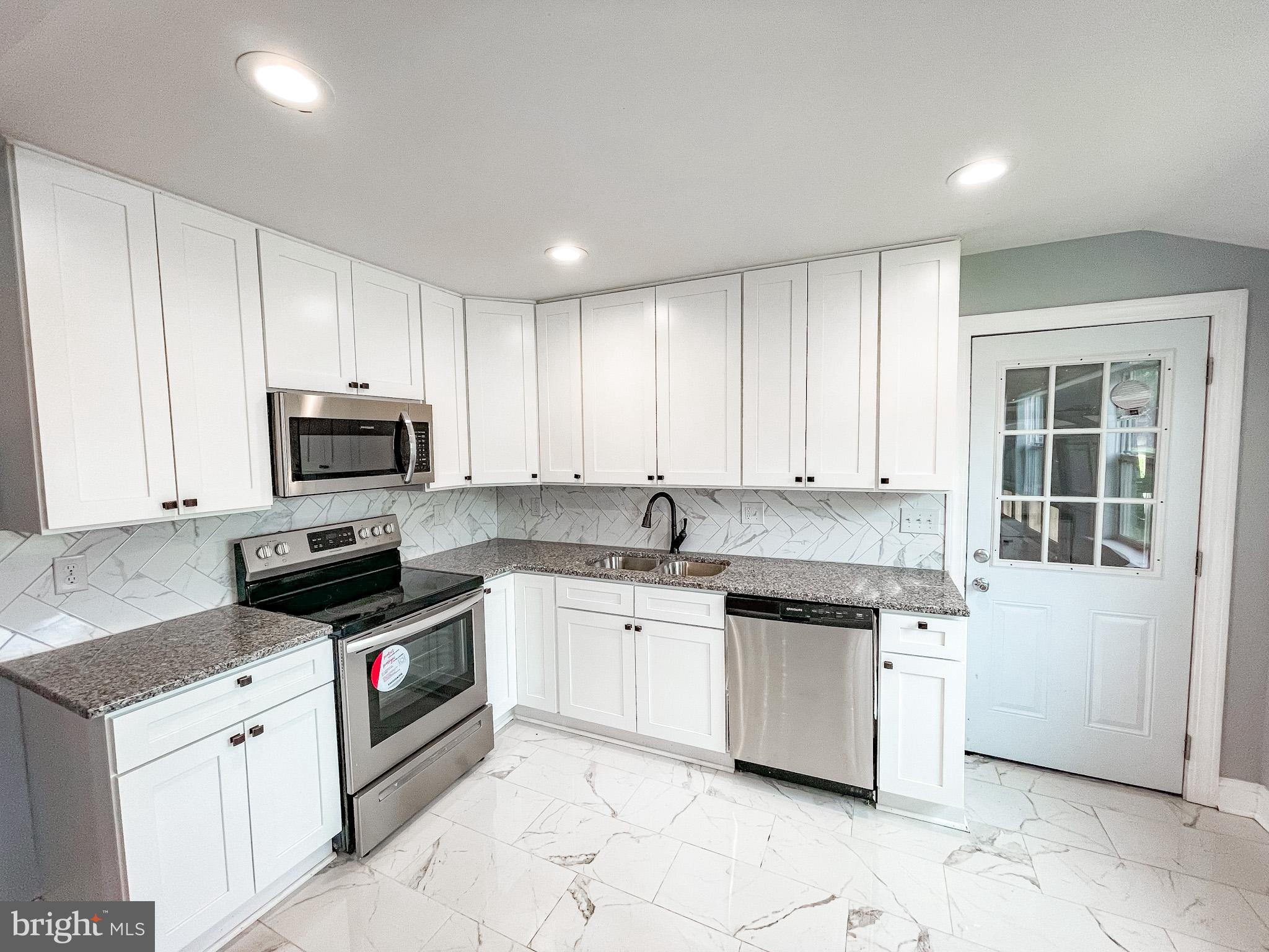 34 Marlyn Road Newark, DE 19713 - Photo 8 of 32 a kitchen with granite countertop white cabinets and stainless steel appliances