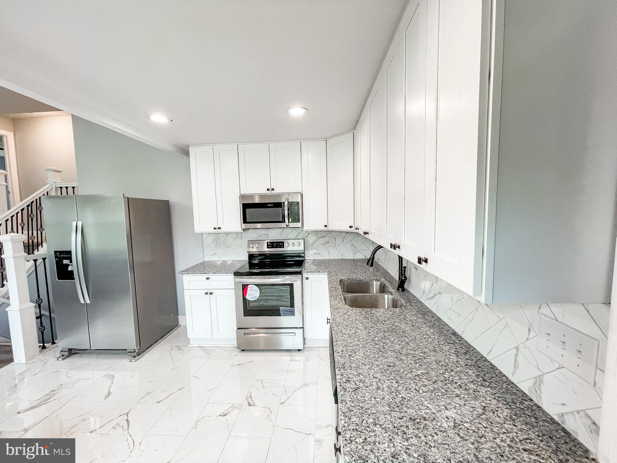 34 Marlyn Road Newark, DE 19713 - Photo 10 of 32 a kitchen with stainless steel appliances granite countertop a refrigerator sink and stove