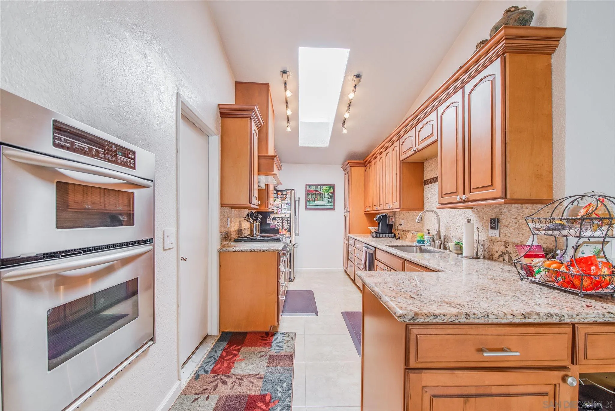 710 Anchor Way Carlsbad, CA 92008 - Photo 13 of 33 a kitchen with stainless steel appliances granite countertop a stove a sink and a microwave