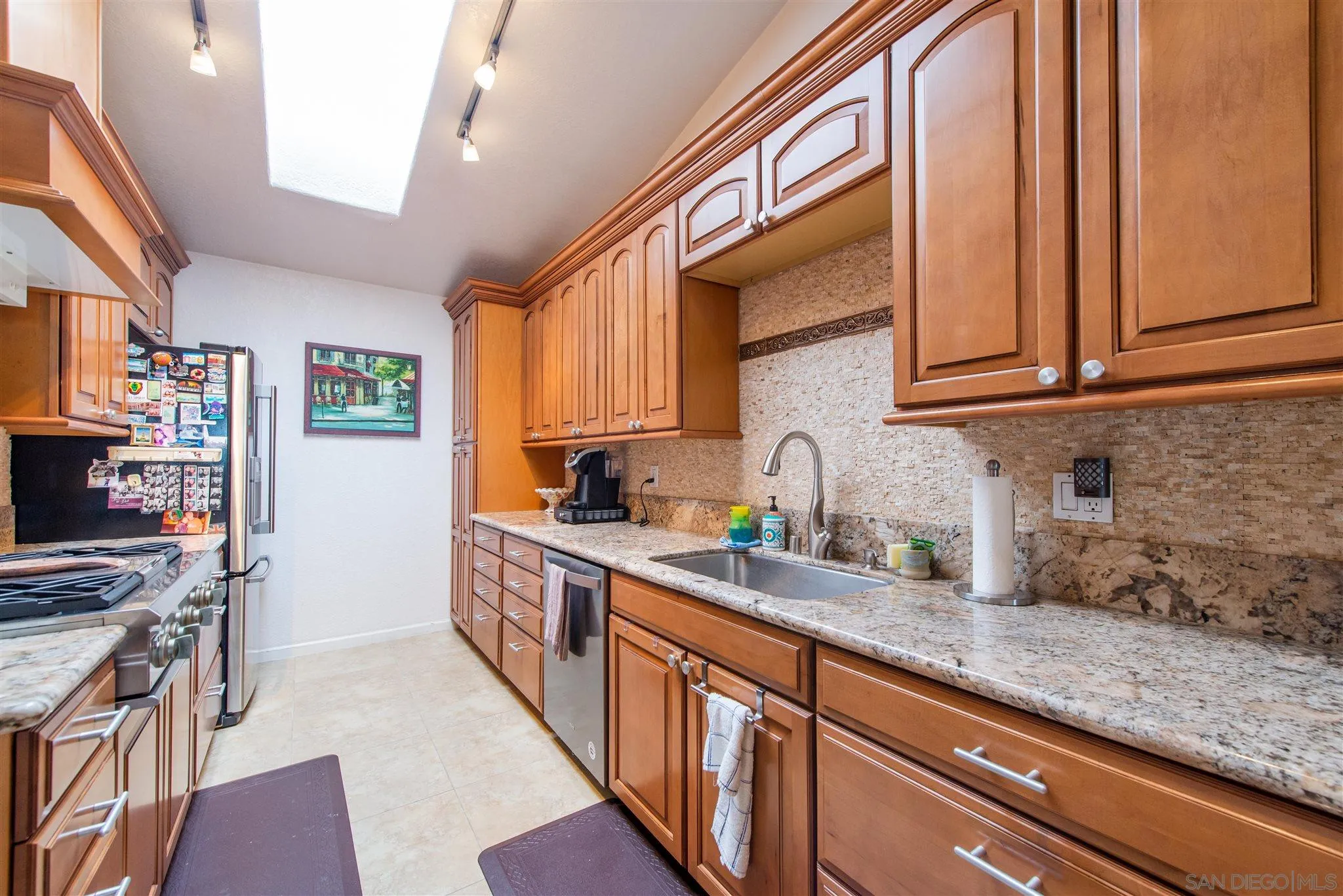 710 Anchor Way Carlsbad, CA 92008 - Photo 16 of 33 a kitchen with stainless steel appliances granite countertop a sink stove and cabinets