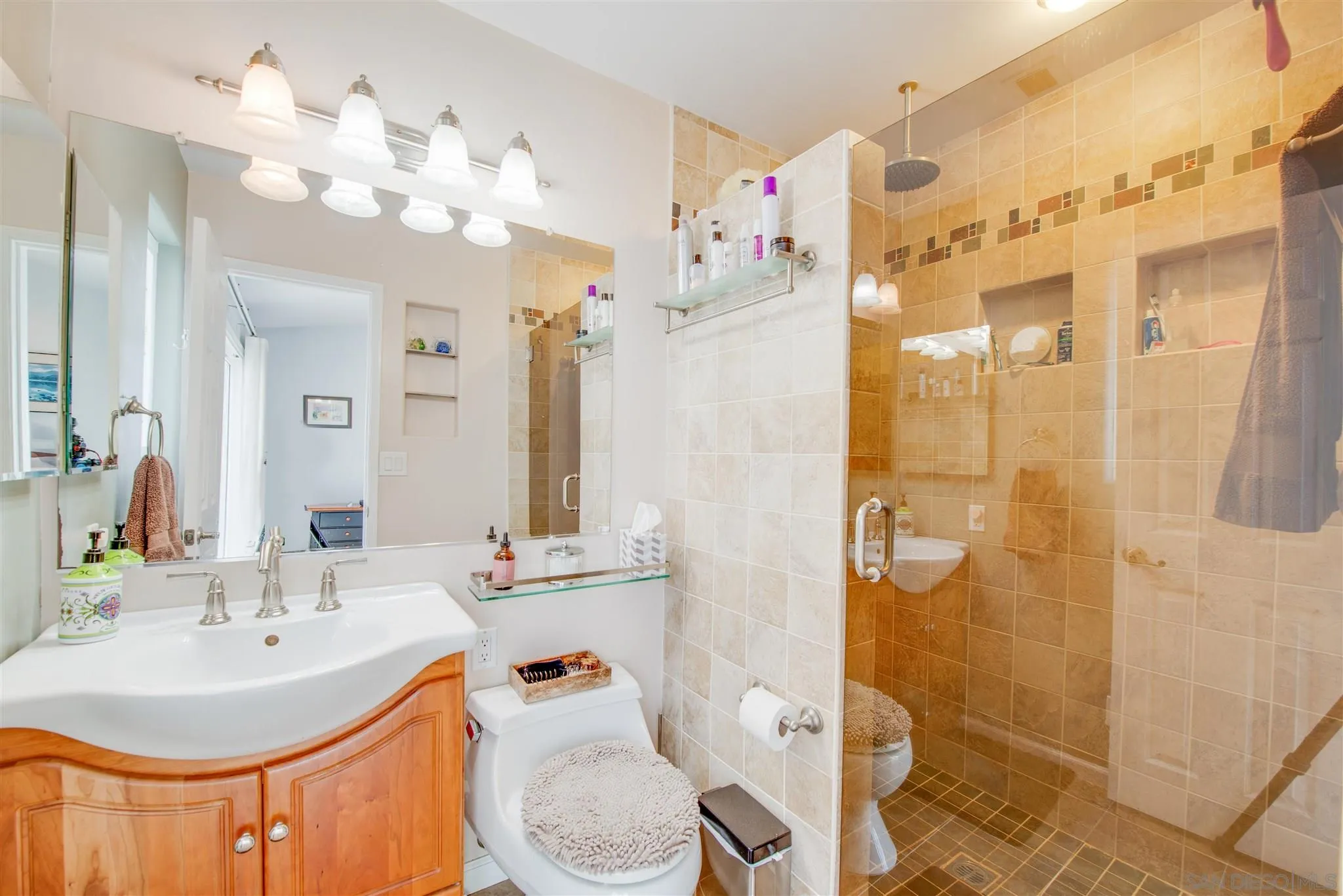 710 Anchor Way Carlsbad, CA 92008 - Photo 20 of 33 a bathroom with a sink a toilet a mirror a vanity and shower